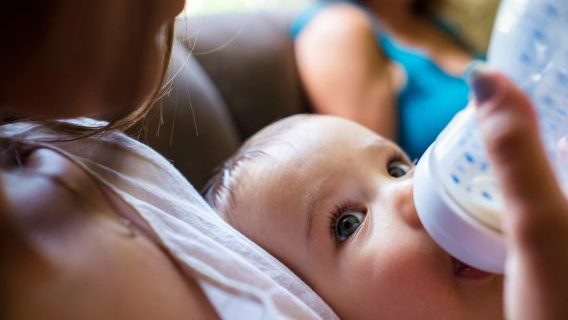 Baby being fed with a bottle