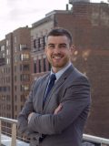 Man smiling, wearing a suit