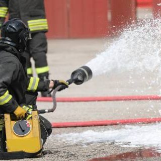 Firefighter using foam