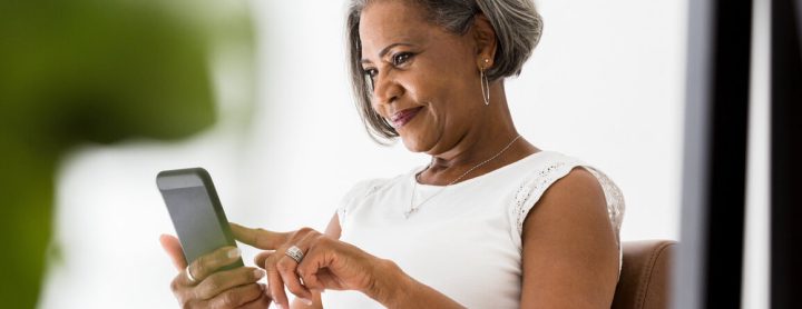 Woman smiling at phone screen