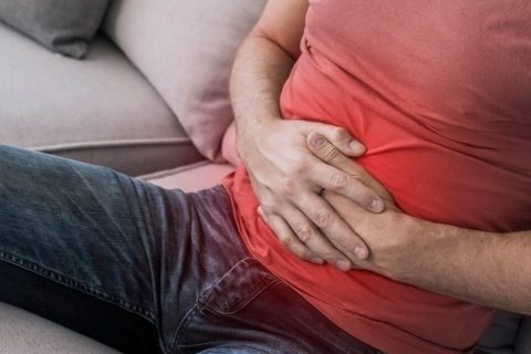 Man holding his stomach in pain