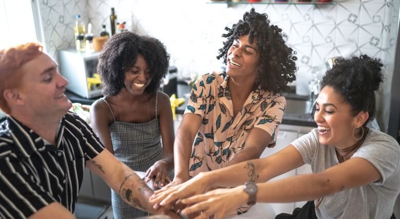 LGBTQ+ friends putting hands together for unity