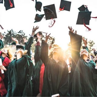 graduates throwing hats in the air