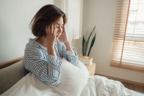 Woman waking up with headache